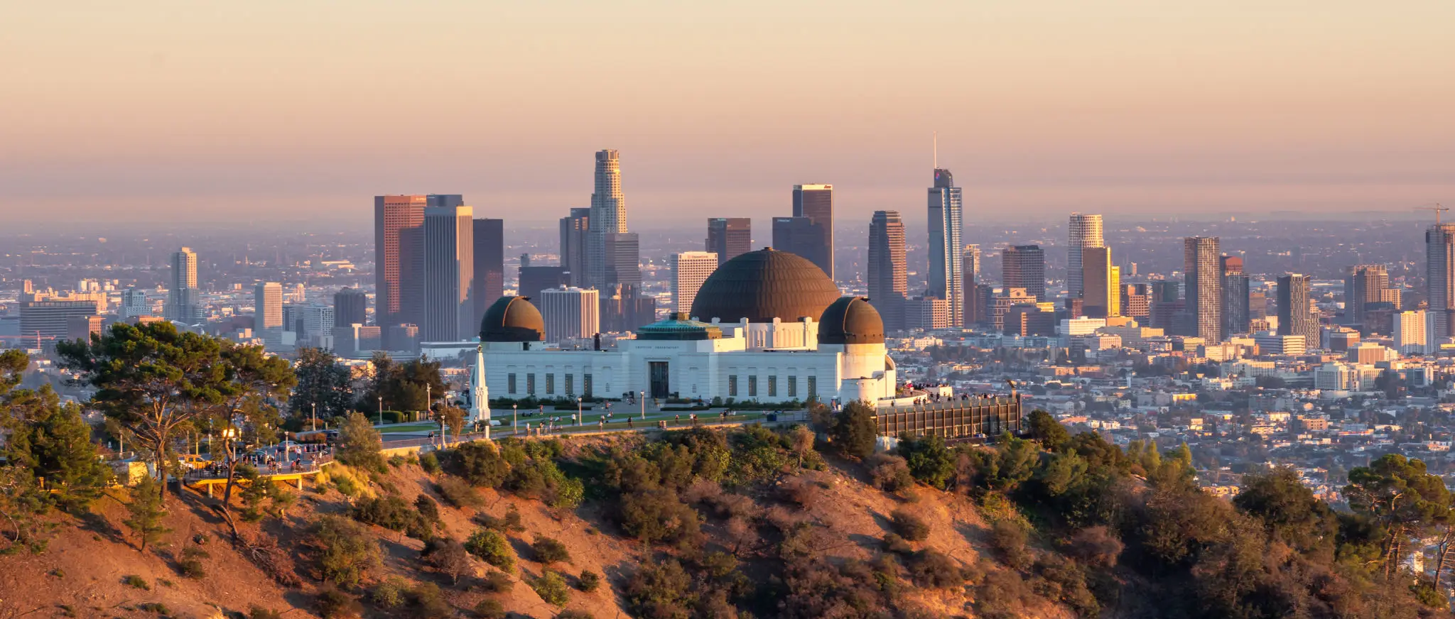 Griffith Observatory overlooking Los Angeles skyline at sunset